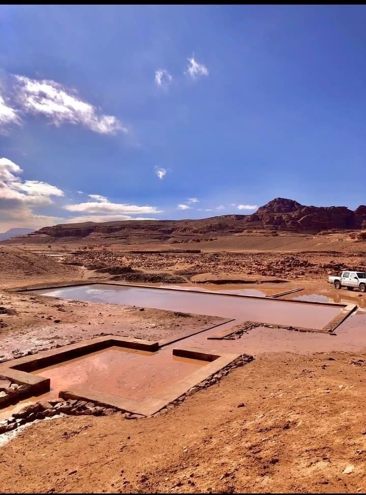 A large rectangular pool in a desert</p>
<p>AI-generated content may be incorrect.